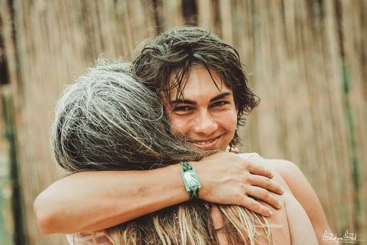 Noah and his mother embrace, a testament to the transformative power of Iboga for healing mental illness, addiction, and trauma. Their shared journey inspired the creation of Ngonde, offering hope for those seeking authentic Bwiti healing